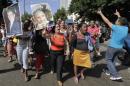 A government supporter hold pictures of former Cuban President Fidel Castro and his brother in Havana