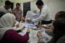 Officials count the ballots after the polls are closed in Cairo