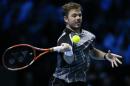 Switzerland's Stan Wawrinka plays a return to Switzerland's Roger Federer during their singles ATP World Tour Finals semifinal tennis match at the O2 Arena in London, Saturday, Nov. 15, 2014. (AP Photo/Kirsty Wigglesworth)