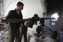 A Free Syrian Army fighter positions a cannon inside a house in Jobar, Damascus