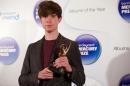 British singer-songwriter and producer James Blake poses with the 2013 Mercury Prize winners trophy for his second album Overgrown during the awards ceremony in central London on October 30, 2011