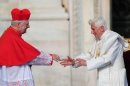 Pope Benedict XVI (R) is greeted by the archbishop of Milan Cardinal Angelo Scola