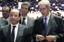 France's President, Francois Hollande, left, and Chief Executive of French carmaker PSA Peugeot Citroen Philippe Varin, right, are seen on the eve of the opening of the Paris Auto Show, Friday, Sept. 28, 2012. The Paris Auto Show will open its gates to the public from Sept. 29 to Oct. 14. (AP Photo/Philippe Wojazer, Pool)