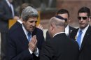 U.S. Secretary of State Kerry greets an Israeli official before a ceremony at Yad Vashem in Jerusalem