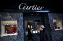In this Sept. 26, 2012 photo, a woman walks by a Cartier jewelry store along Alvear Avenue in the Recoleta neighborhood in Buenos Aires, Argentina. The world's most luxurious designer brands are abandoning Argentina rather than complying with tight new government economic restrictions, leaving empty shelves and storefronts along the capital's elegant Alvear Avenue, where tourists once flocked to see the latest in fashion. (AP Photo/Natacha Pisarenko)
