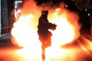 A molotov coctail explodes in front of riot police on September 25, 2013 in Athens