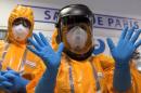 Staff of the emergency medical services in France (SAMU) wear Ebola virus protection outfits during a press presentation at the Necker Hospital in Paris