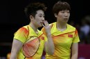 China's Yu Yang, left, and Wang Xiaoli talk while playing against Jung Kyun-eun and Kim Ha-na, of South Korea, in a women's doubles badminton match at the 2012 Summer Olympics, Tuesday, July 31, 2012, in London. World doubles champions Wang and Yu, and their South Korean opponents were booed loudly at the Olympics on Tuesday for appearing to try and lose their group match to earn an easier draw. (AP Photo/Andres Leighton)