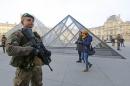 Armed French soldiers patrol at the Louvre Museum as emergency security measures continue ahead of New Year's eve celebrations in and around the French capital, in Paris