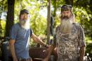 This undated image released by A&E shows brothers Silas "Uncle Si" Robertson, left, and Phil Robertson from the popular series "Duck Dynasty." Phil Robertson was suspended last week for disparaging comments he made to GQ magazine about gay people. (AP Photo/A&E, Zach Dilgard)