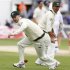 Australia's Clark chases a mis-fielded ball as his captain Ponting looks on during the first Ashes cricket test match in Cardiff