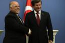 Turkish Prime Minister Ahmet Davutoglu, right, and his Iraqi counterpart Haider al-Abadi shake hands after a news conference in Ankara, Turkey, Thursday, Dec. 25, 2014.(AP Photo)
