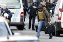 Belgian police investigators arrive outside an apartment in central Verviers