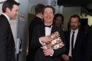 French actor Guillaume Gallienne holds with his trophy during a photocall after receiving the Best Actor, Best first Film, Best adaptated Screenplay and best film awards in the film Me, Myself and Mum at the 39th Cesar Awards ceremony