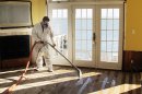 In this Jan. 24, 2013 photo, Victor Pena of Flag Enterprises steam-cleans a floor in a home in Massapequa, N.Y. Homeowners in New York and New Jersey are struggling to combat outbreaks of mold from water-logged homes in the wake of Superstorm Sandy. (AP Photo/Frank Eltman, File)