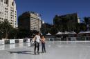 Andrea Davis and her daughter Luna Rivera, 10, ice skate at the Holiday Ice Rink Downtown Los Angeles, Tuesday, Jan. 6, 2015. A Central and Southern California heat wave has set records with highs topping 80 degrees in the dead of winter. The National Weather Service says Santa Maria's airport recorded a maximum temperature of 82 on Tuesday, two degrees above records for the day set in 1962 and 1918. (AP Photo/Nick Ut)