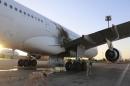 A damaged aircraft is pictured after a shelling at Tripoli International Airport