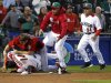 Canada's Jay Johnson, top left, and Mexico's Eduardo Arredondo fight during the ninth inning of a World Baseball Classic game, Saturday, March 9, 2013, in Phoenix. (AP Photo/Matt York)