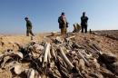Bones, suspected to belong to members of Iraq's Yazidi community, are seen in a mass grave on the outskirts of the town of Sinjar