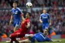 Liverpool's Luis Suarez, centre left, is thwarted by Chelsea's Branislav Ivanovic during their English Premier League soccer match at Anfield Stadium, Liverpool, England, Sunday, April 27, 2014. (AP Photo/Jon Super)
