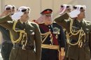 Jordan's King Abdullah reviews an honour guard prior to the opening of the first session for the new parliament in Amman