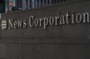 A passer-by stands in front of the News Corporation building in New York
