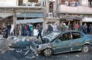 A picture released by the official Syrian Arab News Agency on October 24, 2013 is said to show people inspecting the site of a car bomb explosion in the central city of Homs