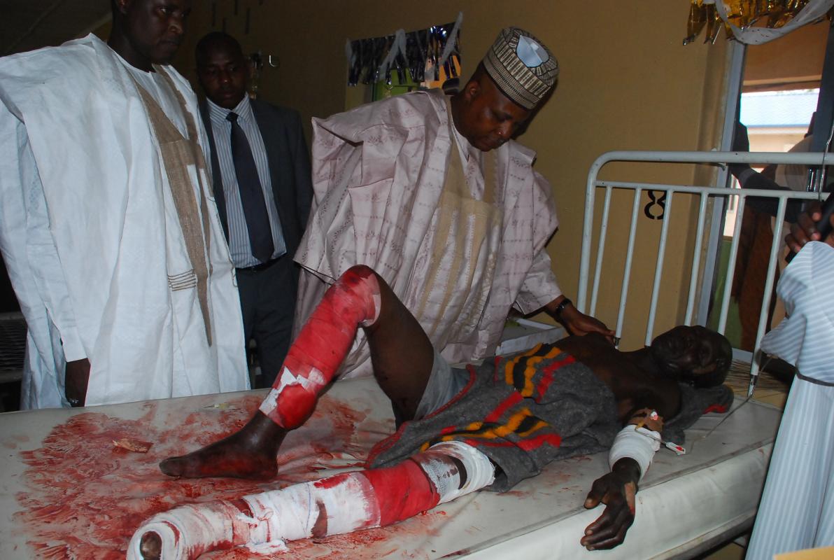Borno state governor Kashim Shettima, speaks to a victim of suicide bomb attack receiving treatment at a specialist hospital in Maiduguri, Nigeria, Tuesday, Nov. 25, 2014. Two female suicide bombers blew themselves up Tuesday in a crowded market in Nigeria’s northeastern city of Maiduguri, killing at least 30 people, according to witnesses and a security official. Boko Haram, Nigeria's Islamic extremist rebels, are suspected of the bombings, as they have carried out many similar attacks. The bombings highlight Nigeria's ongoing insecurity in which 1,500 people have been killed by the militant's insurgency this year, according to Amnesty International. (AP Photo/Jossy Ola )