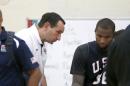 USA head coach Mike Krzyzewski talks with injured DeMarcus Cousins after a practice of the men's U.S. National basketball team Thursday, Aug. 14, 2014, in Chicago. The U.S. team will face the Brazilian team in an exhibition game at the United Center in Chicago Saturday. (AP Photo/Charles Rex Arbogast)