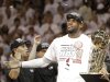 The Miami Heat's LeBron James holds the the Larry O'Brien NBA Championship Trophy after Game 7 of the NBA basketball championship against the San Antonio Spurs, Friday, June 21, 2013, in Miami. The Miami Heat defeated the San Antonio Spurs 95-88 to win their second straight NBA championship. (AP Photo/Lynne Sladky