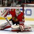 Chicago Blackhawks' goalie Corey Crawford stops a shot by the Detroit Red Wings during the first period of an NHL hockey game in Chicago, Sunday, Jan. 27, 2013. (AP Photo/John Smierciak)