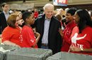 Biden greets volunteers as he arrives to help assemble care kits for U.S. military service members and veterans at a Unite America in Service event at the National Guard Armory in Washington