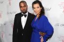 FILE - In this Oct. 22, 2012 file photo Singer Kanye West and girlfriend Kim Kardashian attend Gabrielle's Angel Foundation 2012 Angel Ball cancer research benefit at Cipriani Wall Street in New York. Marriage is coming after the baby carriage for Kim Kardashian and Kanye West. E! News reports West proposed to Kardashian Monday, Oct. 21, 2013, on Kardashian's 33rd birthday, in front of family and friends at the AT&T Park. Kardashian gave birth to the couple's first child, daughter North West, in June. Representatives for 36-year-old West and Kardashian didn't immediately respond to emails seeking comment about the engagement. (Photo by Evan Agostini/Invision/AP, File)