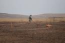 A member of a demining team searches for landmines in Khazer