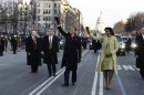 FILE - This Jan. 20, 2009 file-pool, photo shows President Barack Obama and first lady Michelle Obama waving as they walk down Pennsylvania Avenue en route to the White House from the Capitol in Washington. At some point on Inauguration Day, if all goes expected, the president's limousine will slow to a stop on its journey down Pennsylvania Avenue from the Capitol to the White House. A Secret Service agent will open the rear passenger door, and the newly sworn-in president will emerge from his car for a several-minute stroll. The crowd will cheer. The president will wave. In that moment, Pennsylvania Avenue is America's red carpet. And the president is the only celebrity on it. The victory walk has become an iconic inaugural moment, one expected by the public and the press. And though the tradition dates only to President Jimmy Carter, it has already developed an air of inevitability and predictable patterns. (AP Photo/Doug Mills, File, Pool)