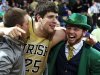 Notre Dame forward Tom Knight (25) celebrates with Leprechaun Bryce Burton following an NCAA college basketball game against Louisville, Saturday, Feb. 9, 2013, in South Bend, Ind. Notre Dame won 104-101 in five overtimes. (AP Photo/Joe Raymond)