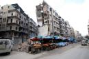 Stalls are seen on a street beside damaged buildings in the rebel held al-Shaar neighborhood of Aleppo