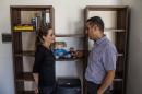 In this image made available from the UNHCR on Monday Sept. 15, 2014 United Nations High Commissioner for Refugees Special Envoy, Angelina Jolie, visits Dr. Ayman Mustafa, a Syrian refugee, at his apartment in Valetta, Malta on Saturday, Sept. 13, 2014. On October 11, 2013 a boat on which he, his wife and daughter boarded to seek refuge, capsized. His wife and daughter drowned. Since the start of 2014, more than 2,500 asylum seekers have perished trying to cross the Mediterranean.. (AP Photo/Pete Muller/Prime for UNHCR)