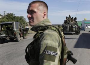 A pro-Russian rebel watches as Ukrainian troops are &hellip;