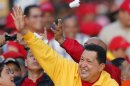 Venezuela's President Hugo Chavez waves at supporters during a campaign rally in Guarenas