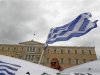 A woman raises a Greek flag during a rally of the "Indignant" group in front of the parliament in Athens
