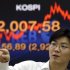 A currency trader reacts near a screen showing the Korea Composite Stock Price Index (KOSPI) at the foreign exchange dealing room of the Korea Exchange Bank headquarters in Seoul, South Korea, Friday, Sept. 14, 2012. Asian stock markets bound higher Friday after investors got just what they wanted - big moves by the Federal Reserve to help the U.S. economy out of its funk. (AP Photo/Lee Jin-man)