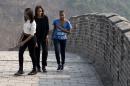 U.S. first lady Michelle Obama walks with her daughters Malia, left, and Sasha, right, as they visit the Mutianyu section of the Great Wall of China in Beijing Sunday, March 23, 2014. (AP Photo/Andy Wong)