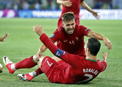 Portugal's Cristiano Ronaldo and Miguel Veloso celebrate their second goal during the Euro 2012 soccer championship Group B match between Portugal and the Netherlands in Kharkiv, Ukraine, Sunday, June 13, 2012. (AP Photo/Armando Franca)
