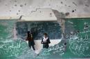 Palestinian girls play inside their school which was destroyed during the 50 days of conflict between Israel and Hamas last summer, in the Shejaiya neighborhood of Gaza City, on November 5, 2014