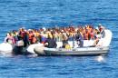 A handout photo taken on February 16, 2014 by the Italian Navy shows immigrants being rescued by the Italian Navy near the Italian island of Lampedusa
