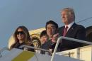 President Donald Trump, right, Japanese Prime Minister Shinzo Abe, second from right, and their spouses, first lady Melania Trump, left, and Akie Abe, second from left, stand at the top of Air Force One at West Palm Beach International Airport in West Palm Beach, Fla., Friday, Feb. 10, 2017. The Trumps are hosting the Abes at their Mar-a-Lago estate in Palm Beach for the weekend. (AP Photo/Susan Walsh)
