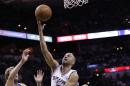 San Antonio Spurs' Tony Parker (9), of France, shoots over Dallas Mavericks' Dirk Nowitzki (41), of Germany, during the first half of Game 7 of the opening-round NBA basketball playoff series, Sunday, May 4, 2014, in San Antonio. (AP Photo/Eric Gay)
