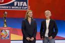 National team soccer coaches, from left, USA's coach Jill Ellis and Sweden's coach Pia Sundhage, pose for a photograph in Gatineau, Quebec, Saturday Dec. 6, 2014, after the FIFA Women's World Cup draw. (AP Photo/The Canadian Press, Fred Chartrand)
