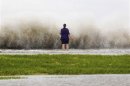 New Orleans resident Diana Whipple stands on the shore of Lake Pontchartrain as tropical storm Isaac approaches New Orleans, Louisiana